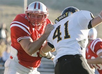 SRSU's 59-year-old senior Mike Flynt blocks on an extra-point attempt during the Lobos' 45-42 triple overtime win over Texas Lutheran.