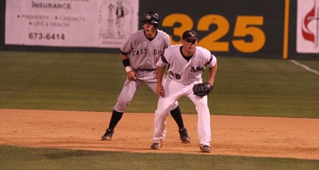 McMurry first baseman Brent Voorhees (28) gets prepared for a pitch on Wednesday while Cal State-East Bay's Marc Tuttle looks on.