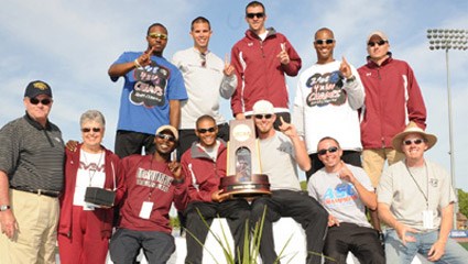 The McMurry men's track and field team poses with the national championship trophy.