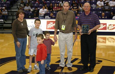 Eric Drennan (second from right) accepts the ASC Outstanding Media Service Award by UMHB Vice-President for Athletics Ben Shipp on Saturday, January 31, 2009, in Belton, Texas. Drennan is joined by his wife, Kristi, and three sons, Alec, Samuel and Eli.